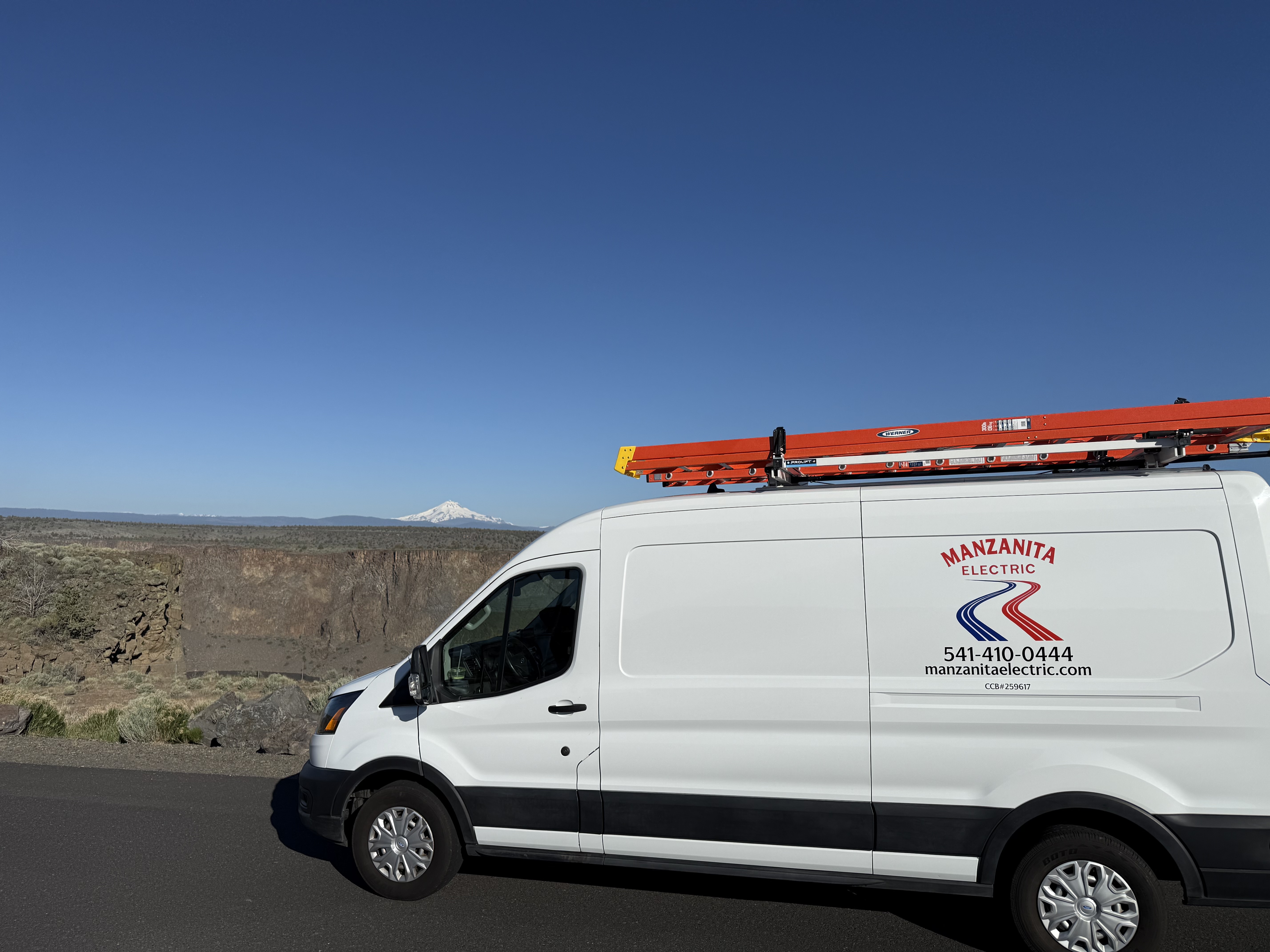Manzanita Electric van in Bend, Oregon with the Cascade Mountains behind